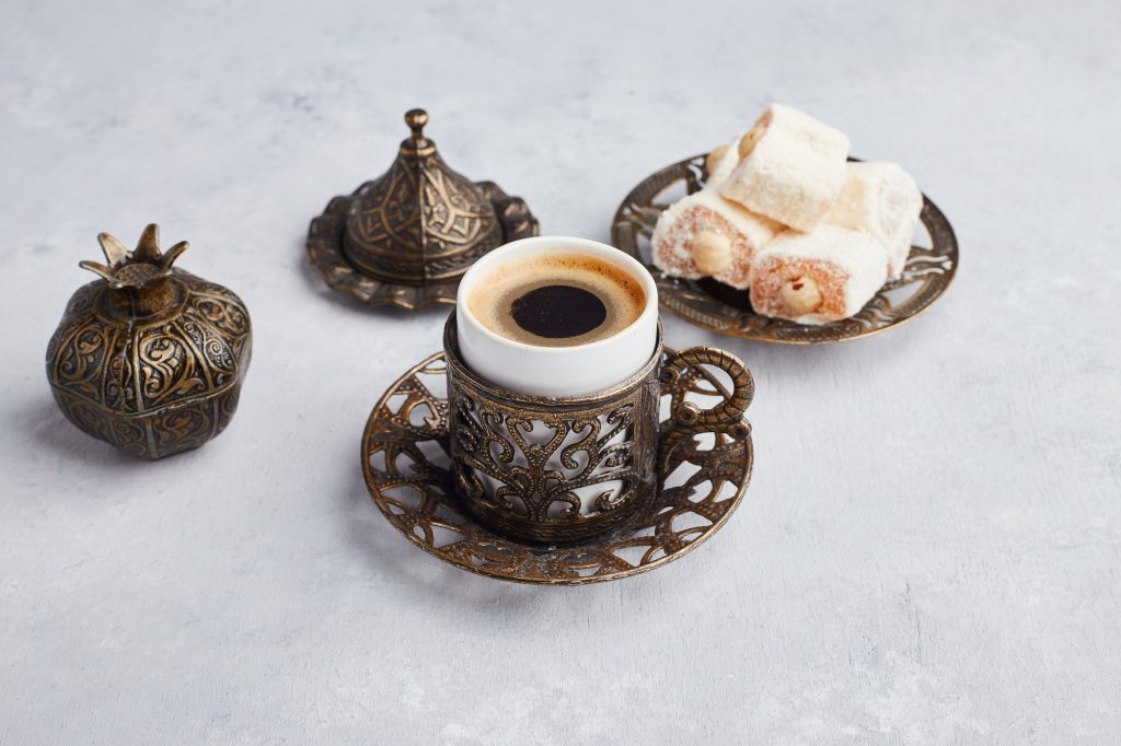 a-cup-of-coffee-served-with-turkish-lokum-on-white-table